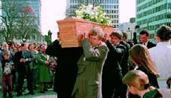 Pallbearers carry the coffin of John Britten past hundreds of mourners into Christchurch Cathedral